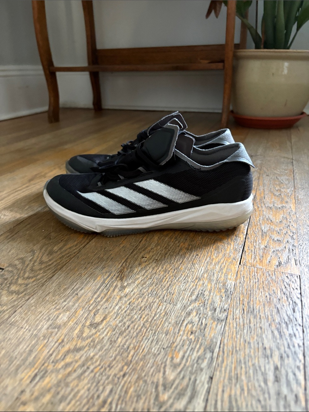 Adidas black and white turf shoes